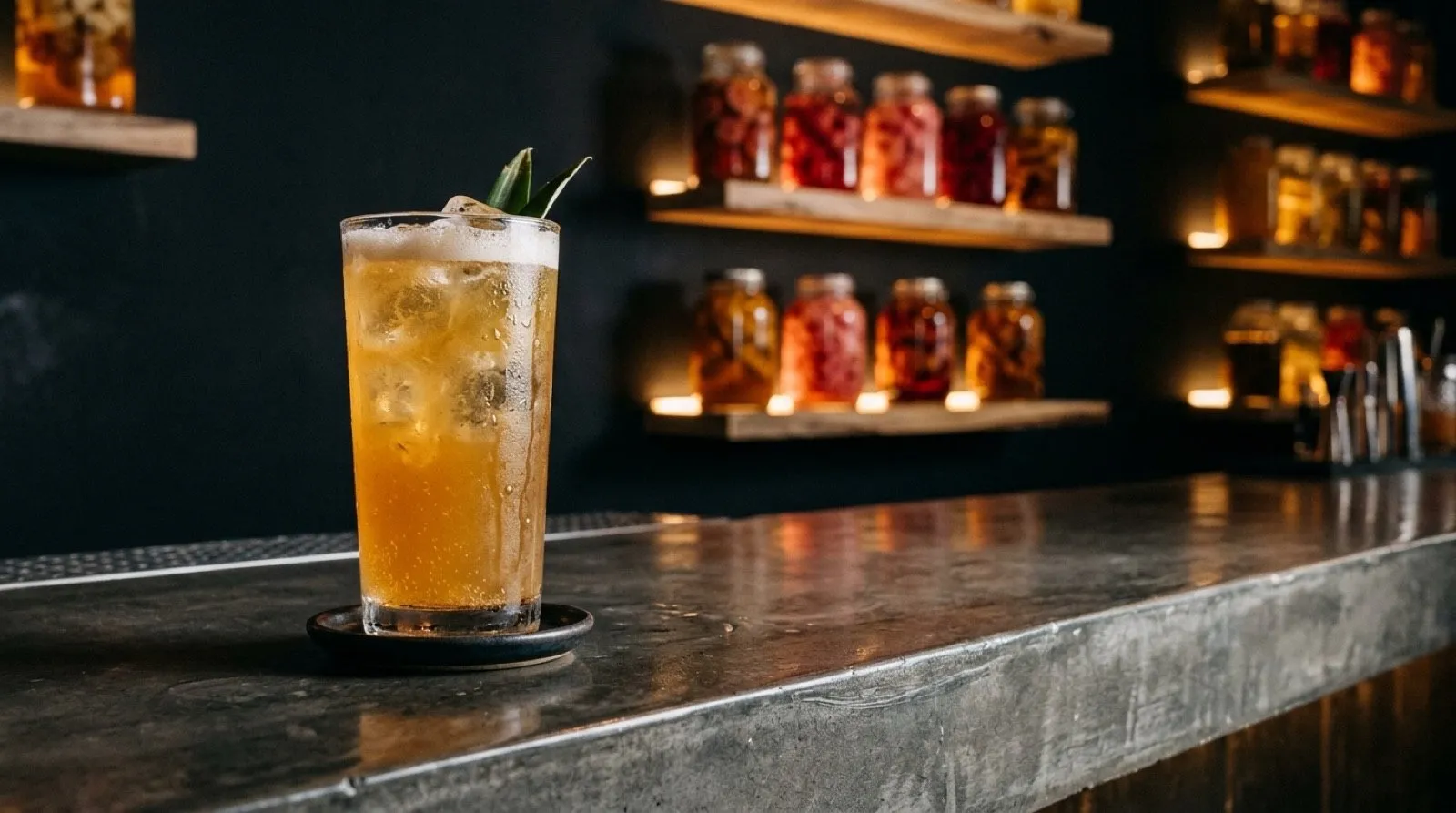 Glass of roasted pineapple tepache, the house’s alcohol-free ferment, for a snack near the Retiro in Madrid