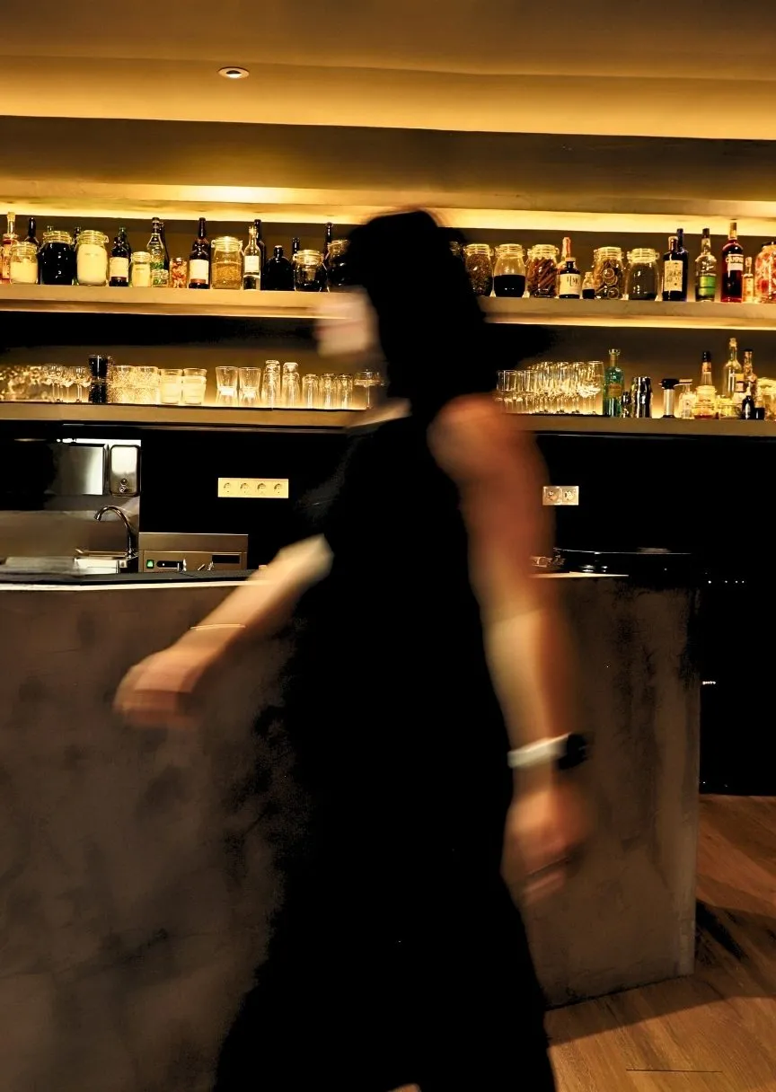 The Stillroom room in motion, with the backlit bar in the background