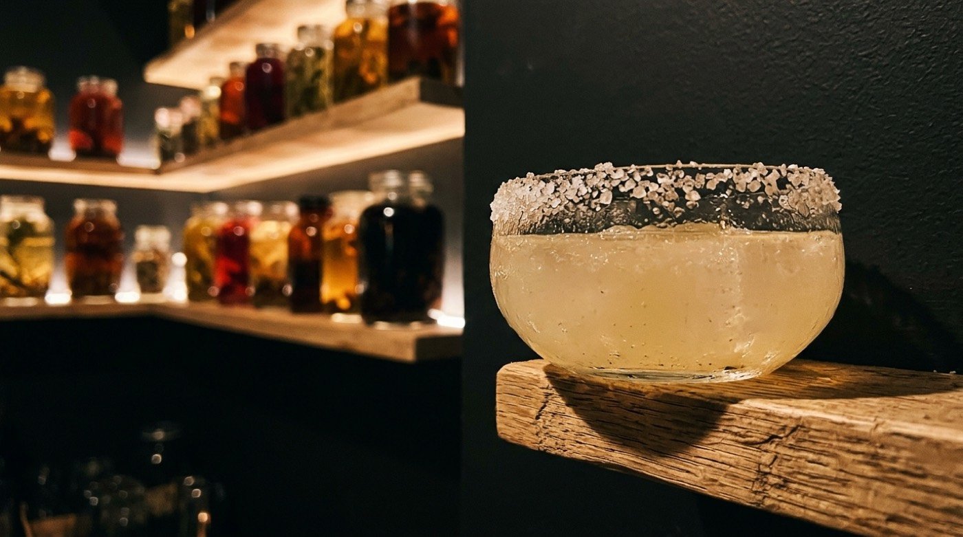 Borde de una copa de cóctel escarchado con sal en primer plano sobre la barra de STILLROOM, coctelería de autor en Madrid